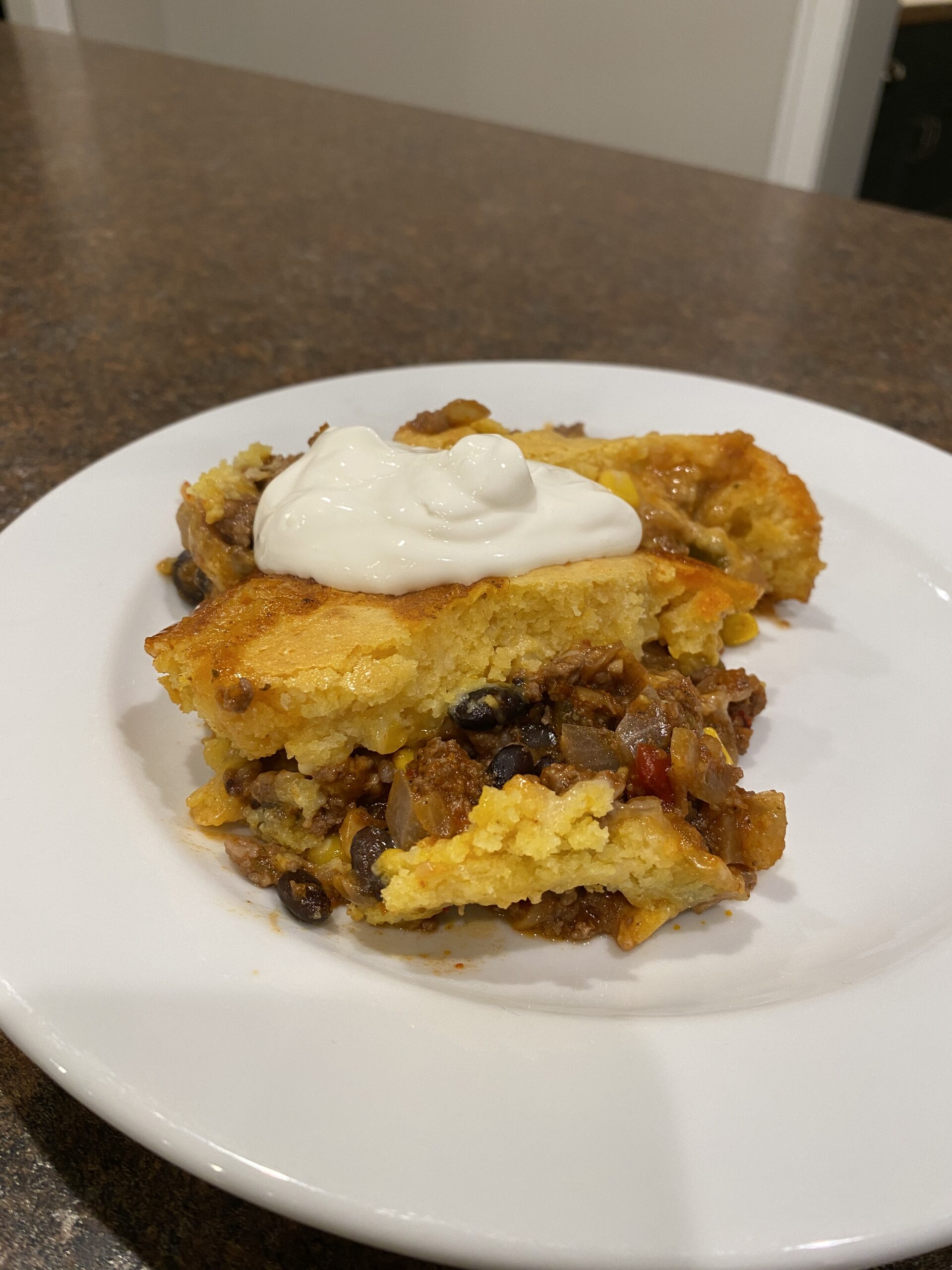 One serving of taco cornbread bake cooling on a plate